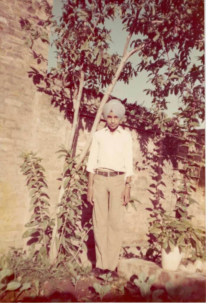 Standing by a Guava Tree in his Backyard, Punjab, 1975. Courtesy of the Kang Family.