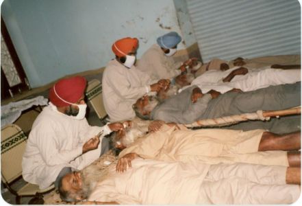Kang (Middle) Performing Eye Surgery on Villagers, India, 1984.  Courtesy of the Kang Family.