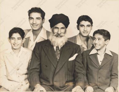 Puna Singh with four of his sons.  Eldest son had been drafted and was away serving in the US army at the time. Yuba City, c. 1945.  Courtesy of the Puna Singh and Nand Kaur Family.
